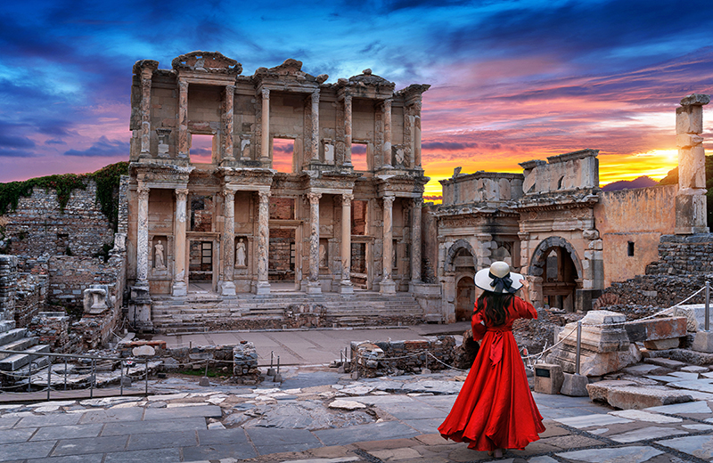 Woman standing in Celsus Library at Ephesus ancient city in Izmir, Turkey.